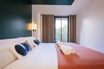 a bedroom with a large bed with towels on it at Sweett - Casa Girona in Barcelona