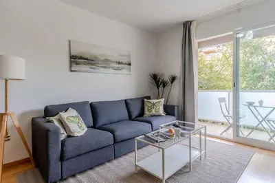 a living room with a blue couch and a glass table at 4207 - AB Sant Adria de Besos in Sant Adria de Besos