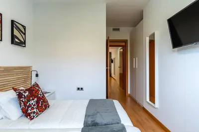 a bedroom with a bed and a flat screen tv at 4207 - AB Sant Adria de Besos in Sant Adria de Besos