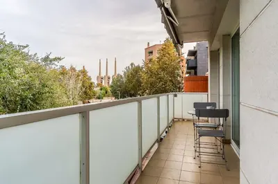 a balcony with chairs and a view of a city at 4207 - AB Sant Adria de Besos in Sant Adria de Besos