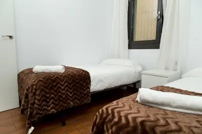 a hotel room with two beds and a mirror at Autèntic Eixample Barcelona in Barcelona