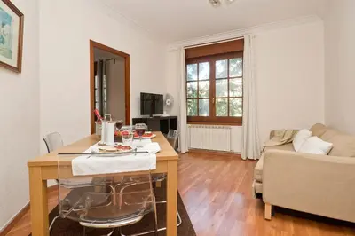 a living room with a table and a couch at Autèntic Barcelona Monumental in Barcelona