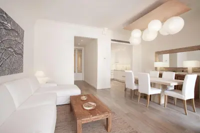a living room with a white couch and a table at Casanova Charm 4BDR Apartment in Barcelona