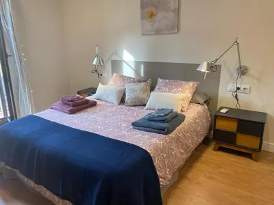 a bedroom with a bed with blue sheets and pillows at Spatious luxe apartment Paseo de Gracia Diagonal in Barcelona