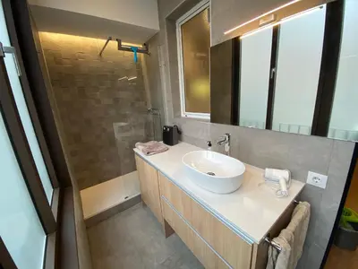 a bathroom with a sink and a mirror at Spatious luxe apartment Paseo de Gracia Diagonal in Barcelona
