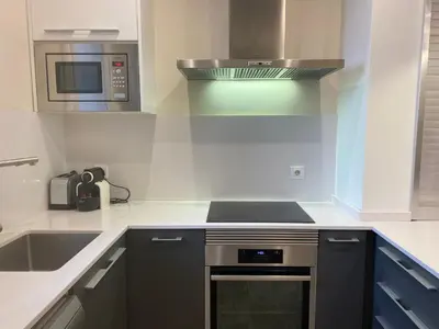 a kitchen with a stove and a microwave at Spatious luxe apartment Paseo de Gracia Diagonal in Barcelona
