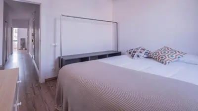 a bedroom with a large white bed with pillows on it at Welcomy Poblenou II in Barcelona