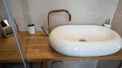 a white sink with a faucet on a wooden counter at Welcomy Poblenou II in Barcelona