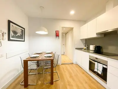 a kitchen with a table and chairs in a room at Boutique Pare Lainez- 2 BR Sagrada Famlia with balcony in Barcelona