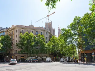 a city street with a building under construction with a crane at Centric Sagrada Familia Apartments in Barcelona