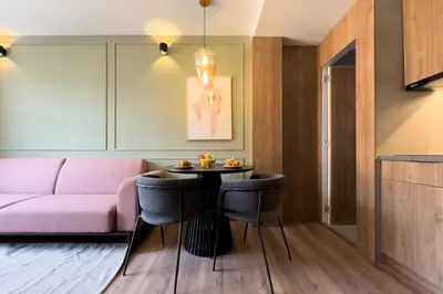 a living room with a pink couch and a table at Boutique Design Apartments & Studios in Barcelona