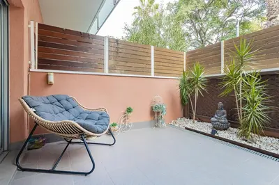 a wicker chair sitting on a patio at Pool LUXURY 2 Bedrooms - 2 Terraces - Parking - Long Term in Barcelona
