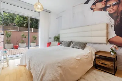a bedroom with a bed with a man and a woman at Pool LUXURY 2 Bedrooms - 2 Terraces - Parking - Long Term in Barcelona