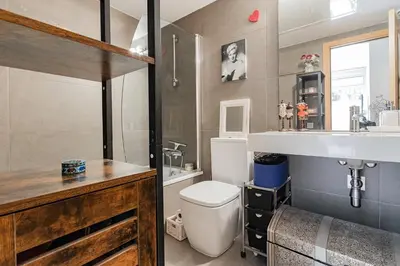 a bathroom with a toilet and a sink at Pool LUXURY 2 Bedrooms - 2 Terraces - Parking - Long Term in Barcelona
