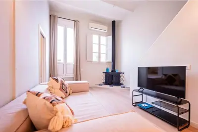 a living room with a couch and a flat screen tv at Sweett - Ethnic Eixample in Barcelona
