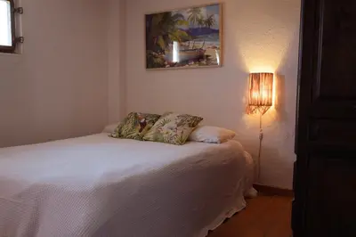 a bedroom with a white bed with a lamp at Villa Alella, 5 bedrooms & pool in Alella
