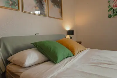 a bed with two green pillows on top of it at Villa Alella, 5 bedrooms & pool in Alella