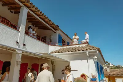 a group of people standing on the balcony of a building at Villa Alella, 5 bedrooms & pool in Alella