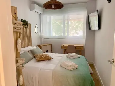 a bedroom with a bed with towels on it at Dolce Terrassa 25 min Barcelona and Beach in Terrassa