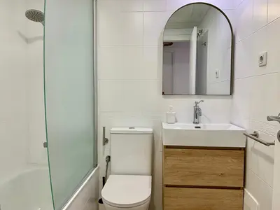 a bathroom with a toilet and a sink and a mirror at Dolce Terrassa 25 min Barcelona and Beach in Terrassa