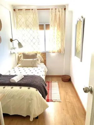a bedroom with a bed and a window at Alojamiento Calma in Hospitalet de Llobregat