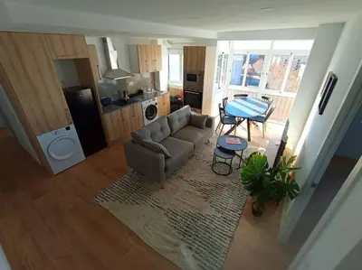 a living room with a couch and a table at Ático cerca Playa y centro a 10 min. in Sant Adria de Besos