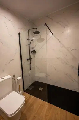 a bathroom with a toilet and a glass shower at jacuzzi privado con vistas increíbles el Raco d Artes in Artés