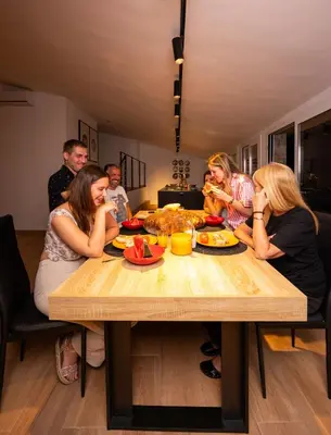 a group of people sitting around a table eating food at jacuzzi privado con vistas increíbles el Raco d Artes in Artés