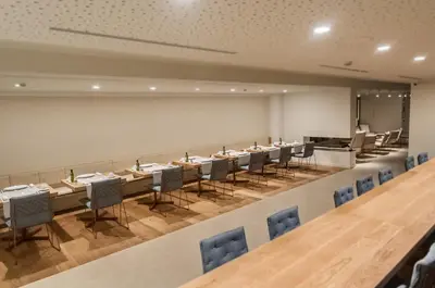 a conference room with long tables and chairs at Hotel Sorli Emocions in Vilassar de Dalt