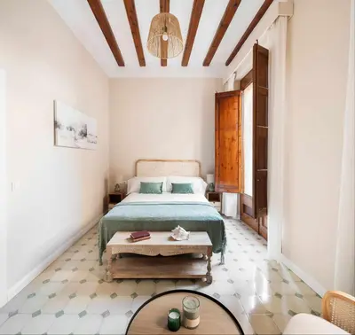 a bedroom with a bed and a table at Casa familiar junto al mar en Arenys de Mar in Arenys de Mar