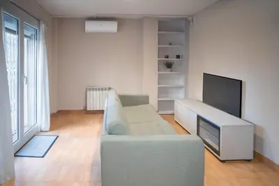 a living room with a couch and a flat screen tv at Comodidad y estilo en Gava near the beach 10 minutes in Viladecáns