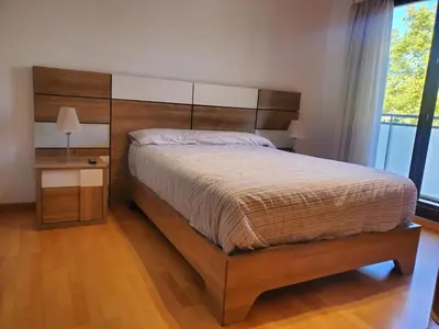 a bedroom with a large bed and a window at Habitacion con Piscina in Sant Cugat del Vallès