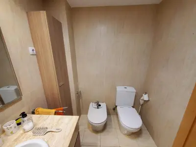 a bathroom with a white toilet and a sink at Habitacion con Piscina in Sant Cugat del Vallès