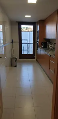 a large kitchen with a view of a balcony at Habitacion con Piscina in Sant Cugat del Vallès