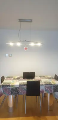 a dining room table with chairs and a laptop on it at Habitacion con Piscina in Sant Cugat del Vallès