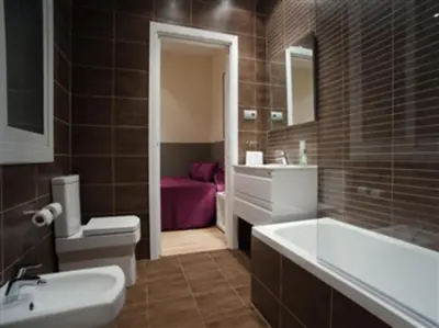 a bathroom with a tub and a toilet and a sink at Easysleep Borne in Barcelona