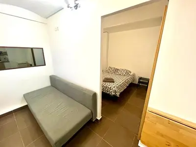 a small room with a couch and a bed at B3 planta baja al lado del metro in Barcelona