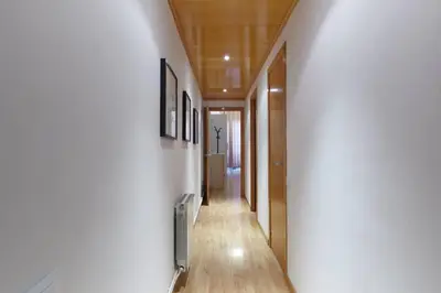a hallway with white walls and wooden floors at Beautiful apartment in Eixample in Barcelona