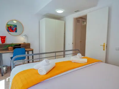 a bedroom with a bed with two towels on it at Happy Diamond by Hello Homes Sitges in Sitges
