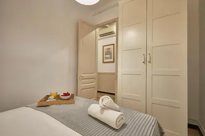 a bedroom with a bed with towels on it at BBarcelona Sagrada Familia Garden Apartment in Barcelona