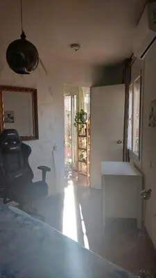 a room with a bed and a table and a sink at Atico Soleado in Esplugues de Llobregat