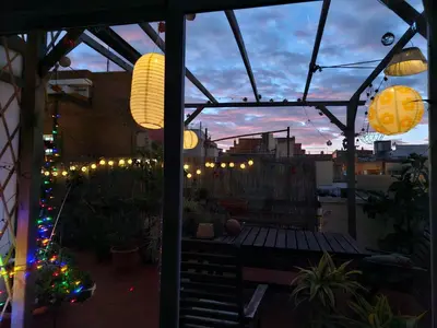 a patio with christmas lights and a christmas tree at Atico Soleado in Esplugues de Llobregat