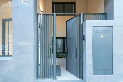 an entrance to a building with a metal door at YOUR HOME- Apartment Camp Nou 1 in Hospitalet de Llobregat