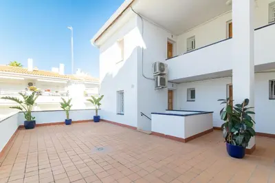 a balcony of a white building with potted plants at Romantic: Precioso frente al mar in Sitges