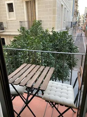 a wooden bench sitting on top of a balcony at 1201 - Encantador Apartamento en Poble Nou in Barcelona