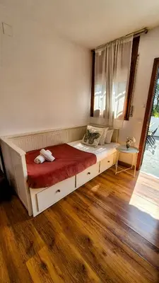 a bedroom with a large bed with a red blanket at Vila Sitges, big house with pool in Sitges