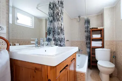 a bathroom with a white sink and a toilet at Rainbow in Barcelona