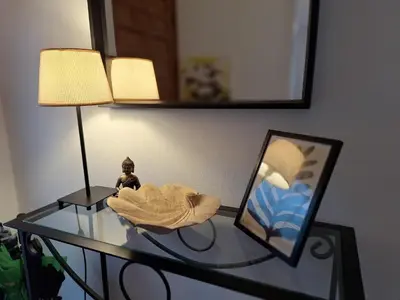 a glass table with a picture and a lamp at Casa Roure-4BR-Piscina privada-BBQ-Vistas Mar in Sant Cebrià de Vallalta