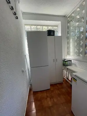 a white refrigerator in a kitchen with a window at Casa Roure-4BR-Piscina privada-BBQ-Vistas Mar in Sant Cebrià de Vallalta