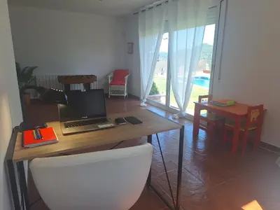 a desk with a laptop computer on top of it at Casa Roure-4BR-Piscina privada-BBQ-Vistas Mar in Sant Cebrià de Vallalta